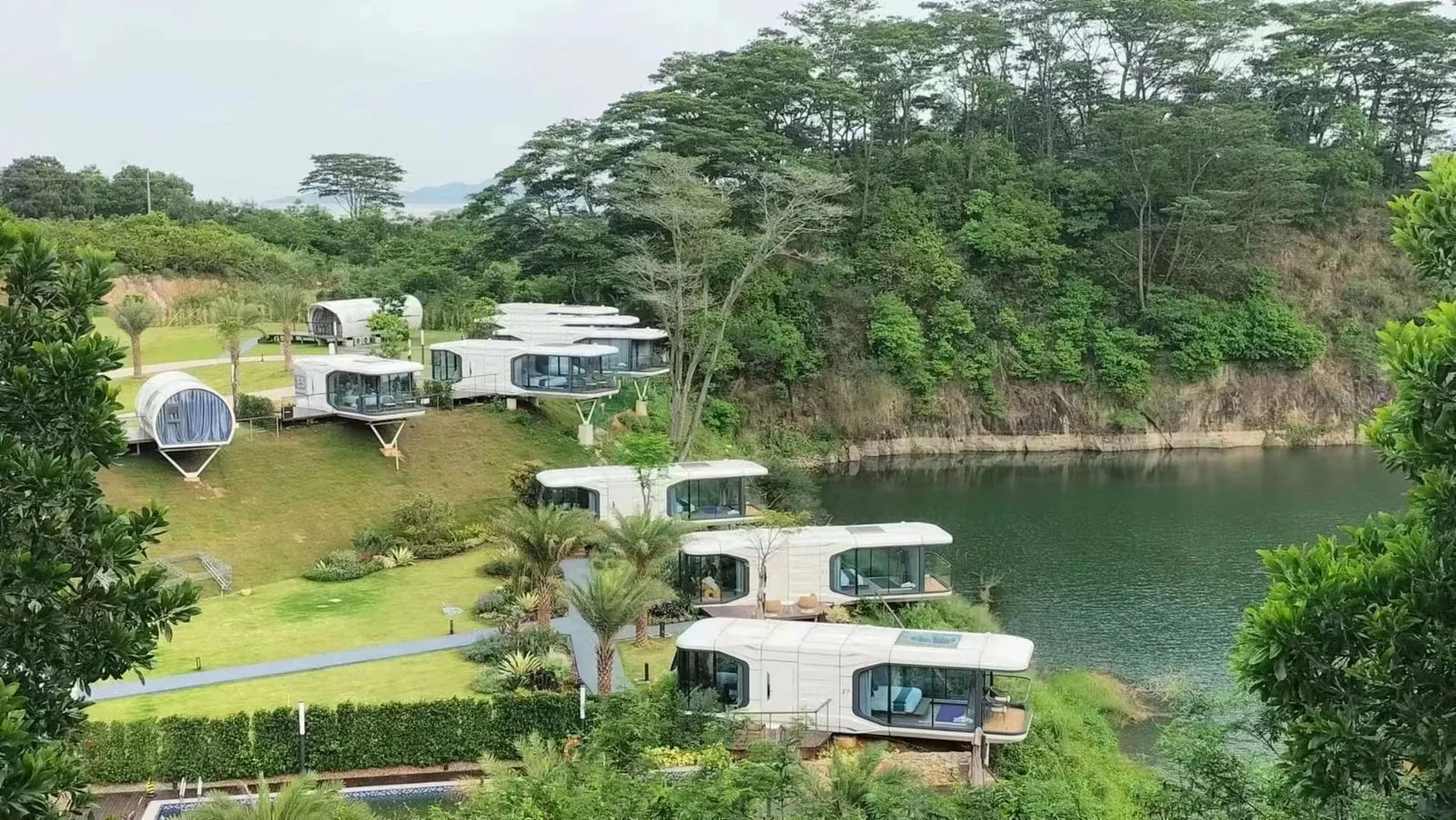 Space capsule units at a lakeside camp
